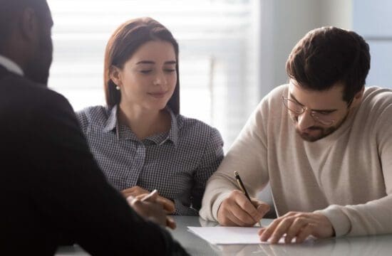couple signing papers