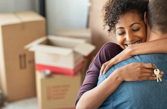 couple hugging with keys in hand