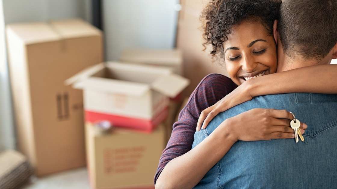 couple hugging with keys in hand