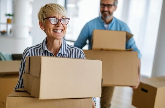 older couple with boxes and carrying boxes