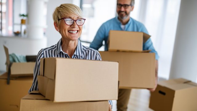 older couple with boxes and carrying boxes