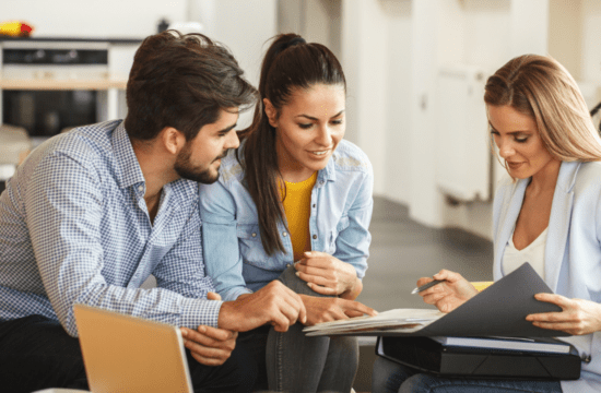 couple reviewing documents with agent