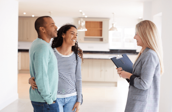 couple meeting with agent in new home