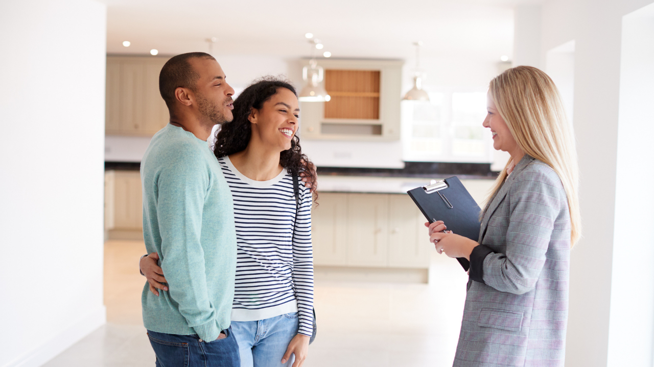 couple meeting with agent in new home