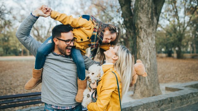 family girl on dad's shoulders