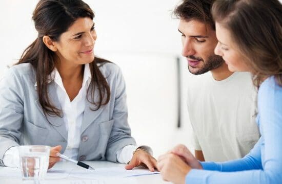 couple reviewing documents with agent