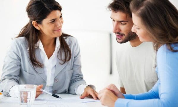 couple reviewing documents with agent