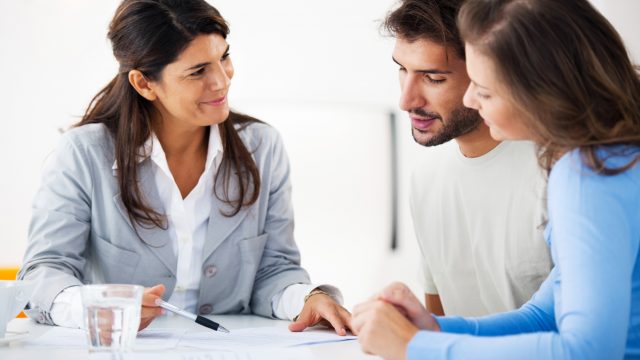 couple reviewing documents with agent