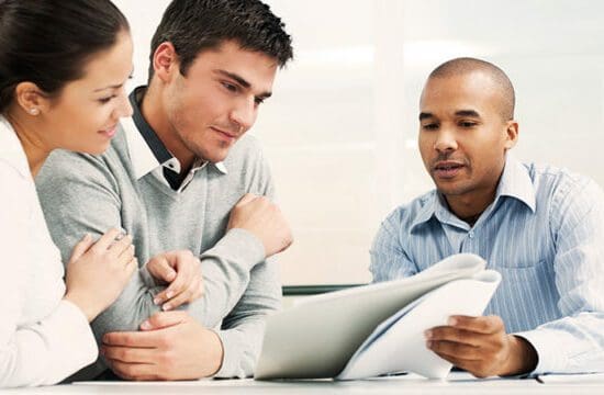 couple reviewing papers with agent