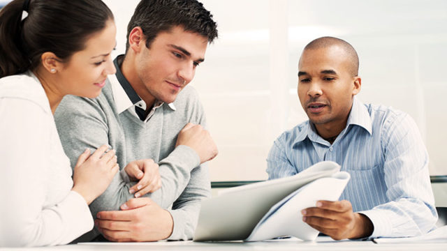 couple reviewing papers with agent