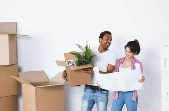 couple with boxes reviewing floor plans