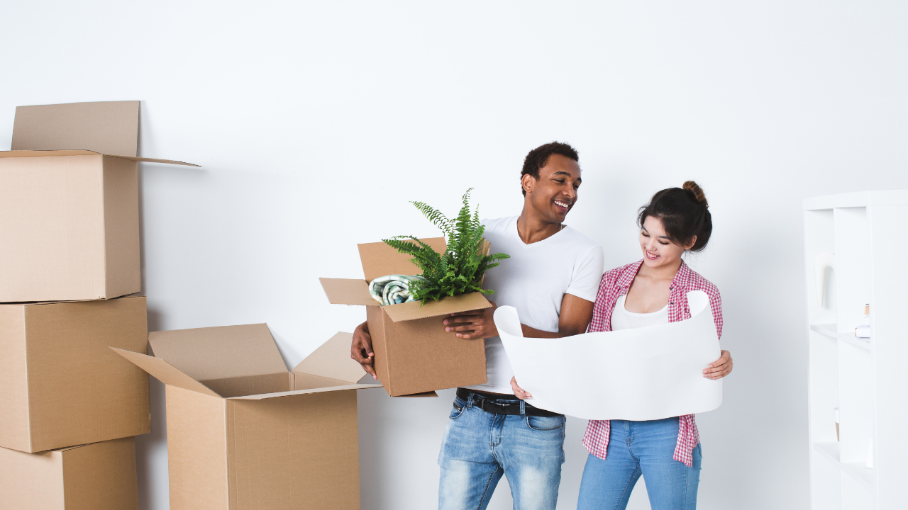 couple with boxes reviewing floor plans